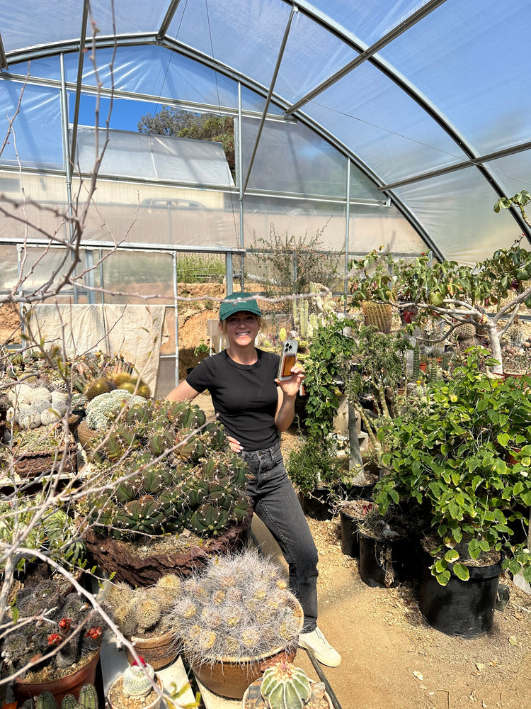 Margo with plants in the greenhouse