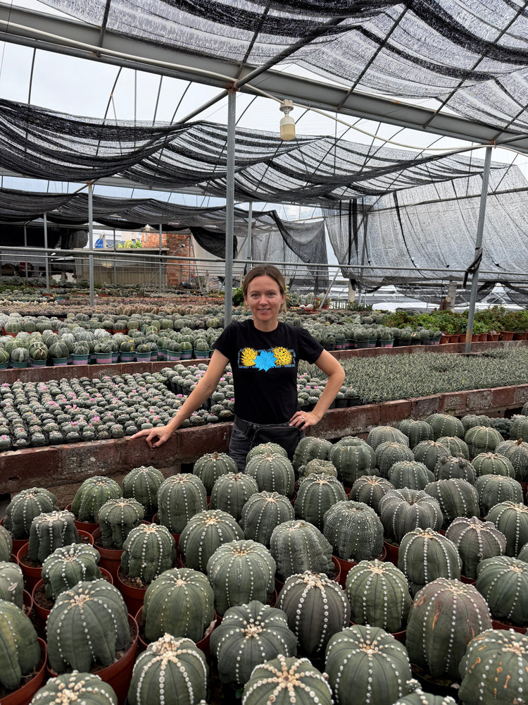 Margo with plants in the greenhouse