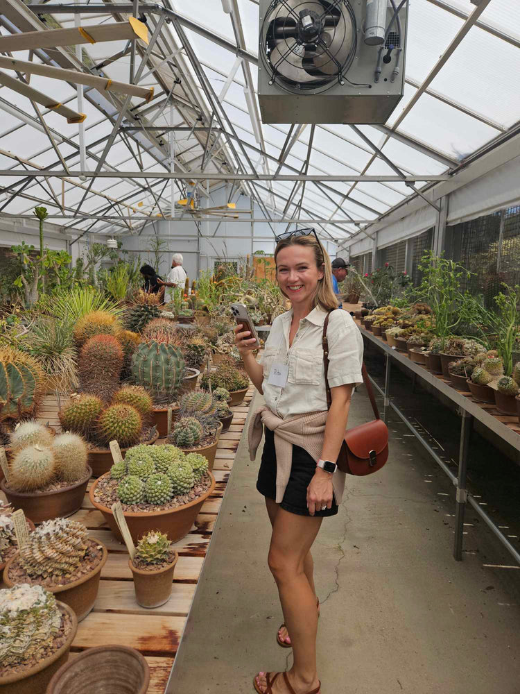 Margo with plants in the greenhouse