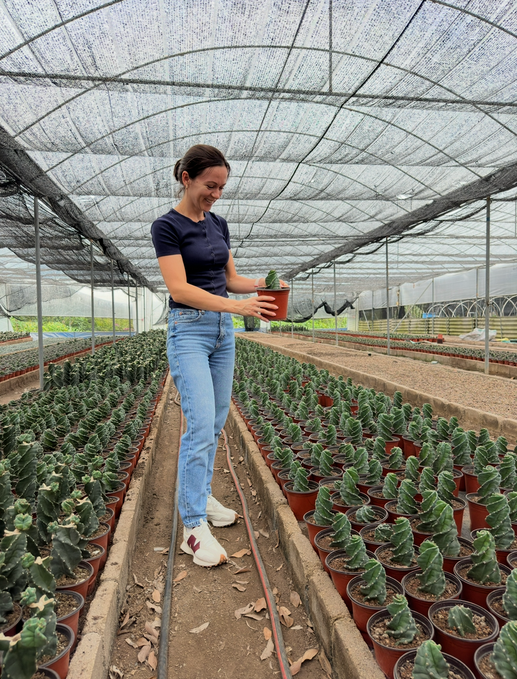 Margo with plants in the greenhouse